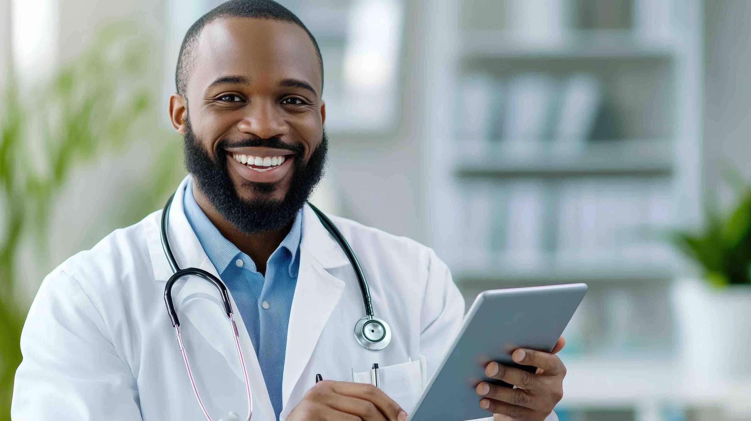 A smiling physician holding a tablet