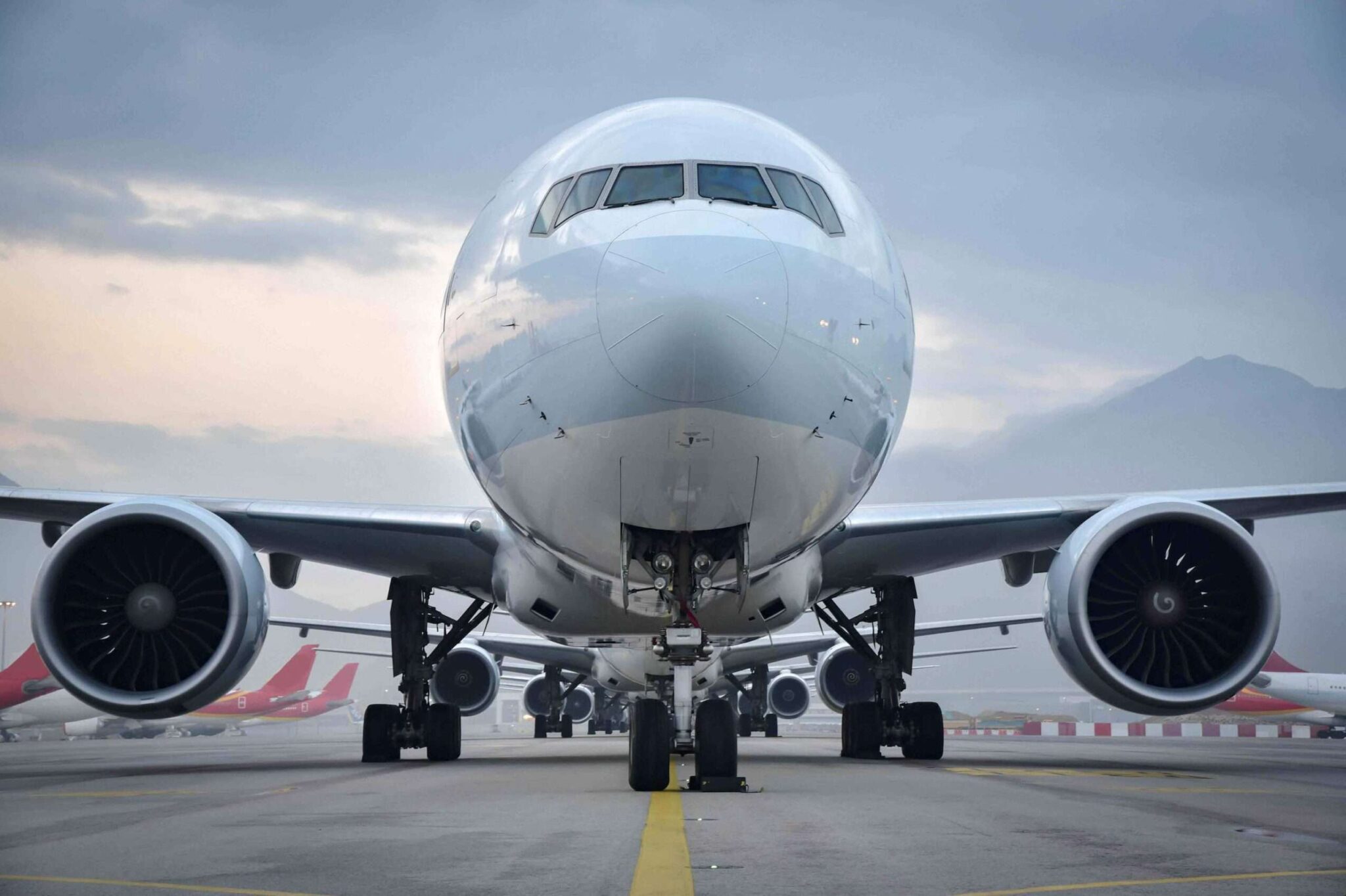 The nose of a commercial aircraft on an airport runway